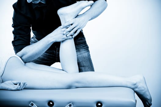 Massage therapist giving a massage. female receiving professional massage. pain concept.
