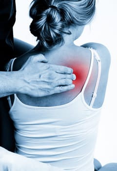 Massage therapist giving a massage. female receiving professional massage. pain concept.