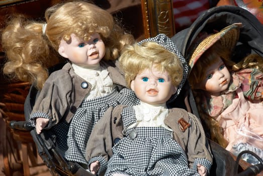 Three old dolls at a flea market.