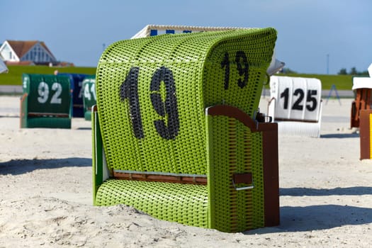 Green single beach chair on the beach of the Baltic Sea