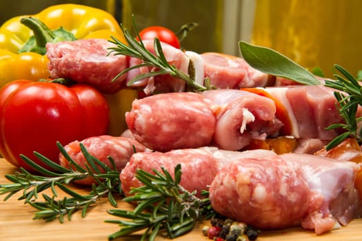 Meat and pepper skewers on a wooden cutting board