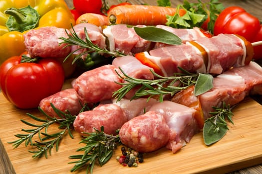 Meat and pepper skewers on a wooden cutting board