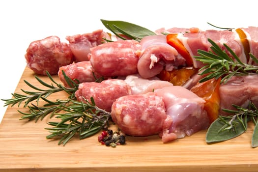 Meat and pepper skewers on a wooden cutting board