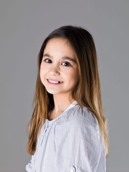 Portrait of a young girl on grey background