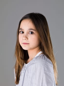 Portrait of a young girl on grey background