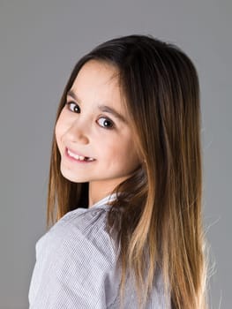 Portrait of a young girl on grey background