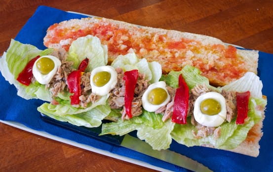Healthy sandwich with fresh red pepper, tomato, olives, tuna and egg for breakfast