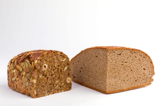 Two cut loaves of bread on white background