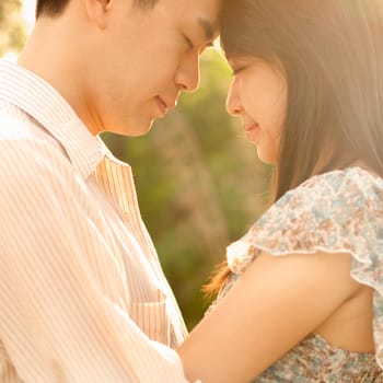Asian couple enjoying in outdoor sunset