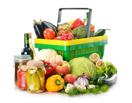 Composition with plastic shopping basket and grocery isolated on white