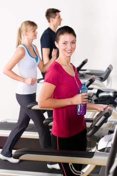 Walking on treadmill young people running exercise at fitness center