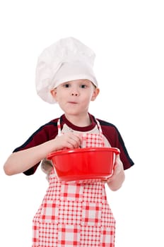 boy in chef&#039 s hat makes the dough in a bowl isolated on white background