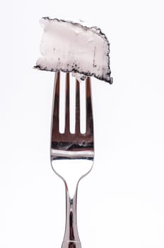 A goat's cheese from France with ash bark on a fork
