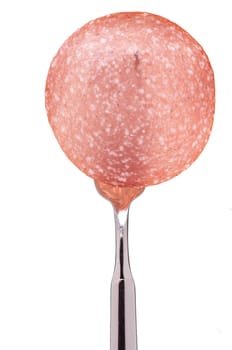 A fork with a slice of salami sausage