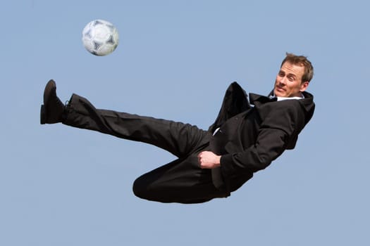 Businessman doing soccer