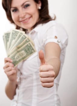 A girl with dollars showing "OK"""