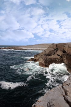 cliffs and coastline of the burren in county clare ireland with waves crashing on the rocks