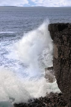 cliffs and coastline of the burren in county clare ireland with waves crashing on the rocks