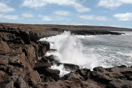 cliffs and coastline of the burren in county clare ireland with waves crashing on the rocks