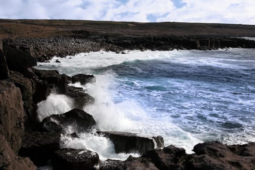 cliffs and coastline of the burren in county clare ireland with waves crashing on the rocks