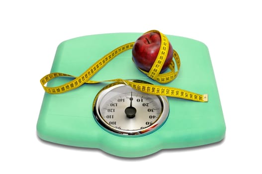 Weight scale with measuring tape and apple