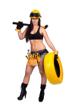 Sexy worker posing against a white background with tires
