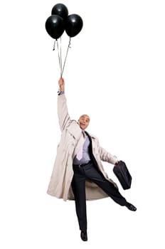 Businessman holding a group of black balloons