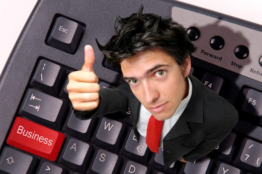 Businessman in a computer keyboard with the word business in red