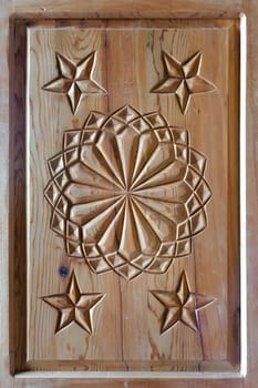 floral tars motifs carved on the old wooden doors. detail