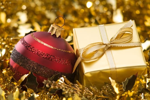golden christmas gift with ornaments close up
