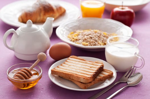 Healthy breakfast on purple background close up