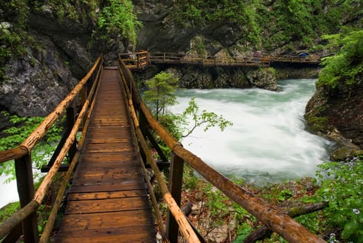 wooden path trough beautiful canyon with river