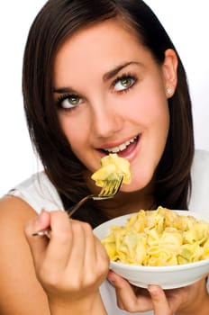 young brunette woman eating pasta close up