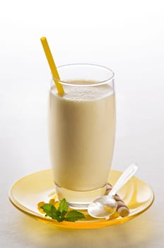 Fresh yellow milkshake with mint close up shoot