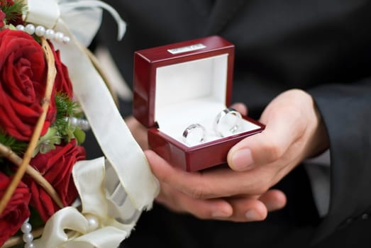 man holding wedding rings close up shoot