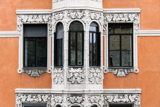 windows on a facade of a palace in Genoa, Italy