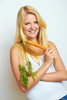 Young healthy woman with carrot