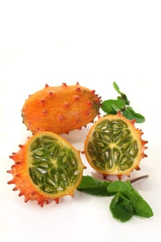 a sliced Kiwano against a white background