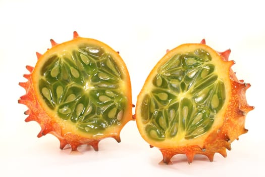 a sliced Kiwano against a white background