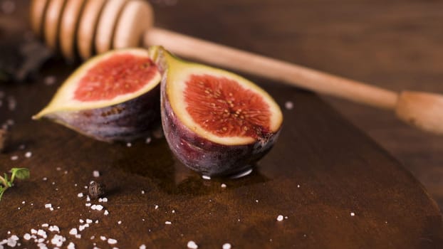 Fresh figs. Whole figs and sliced in half figs on wooden cutting board