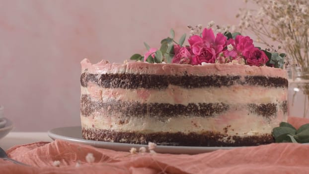 Strawberry cake, strawberry sponge cake with fresh strawberries and sour cream on a pink background.