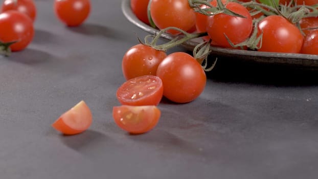 Small red cherry tomatoes on rustic background. Cherry tomatoes on the vine