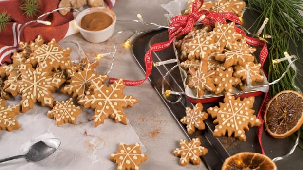 Christmas cookies on kitchen countertop with festive decorations.