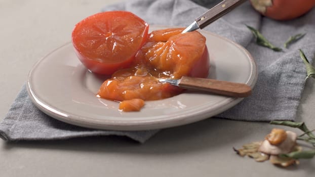 Persimmon fruit on rustic table in vintage style.