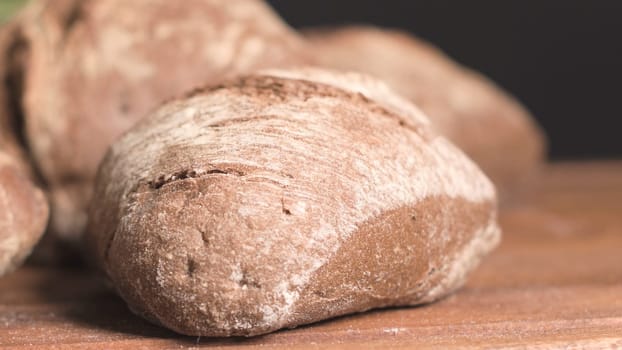 Malt loaf bread on rustic wooden table.