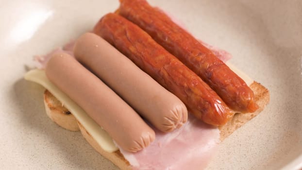 Ingredients preparations of traditional Portuguese snack food. Francesinha sandwich of bread, cheese, pork, ham, sausages. On table.