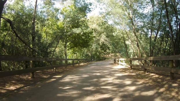 Point of view shot of riding a bicycle at Amarante Cycling Trail in Portugal. Features a wide view of the bike track and the natural scenery as it travels.