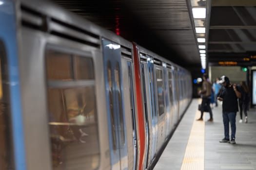 Spacious metro train with passengers, showcasing urban transportation.