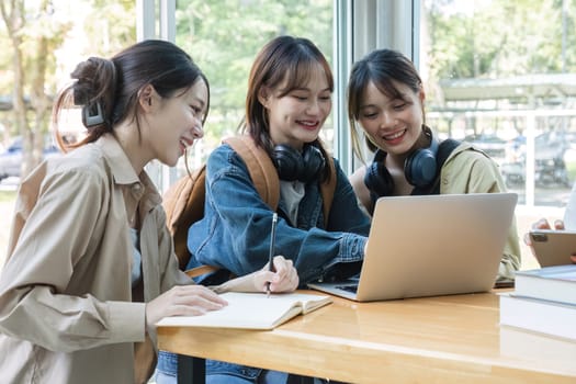 A group of Asian college students join together to share ideas, do homework or study with passion..