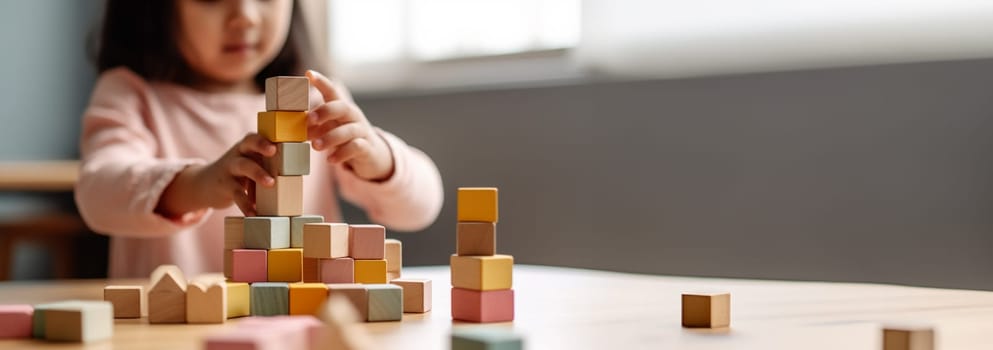 Kid playing with colorful wooden toy blocks. Little boy or girl building tower of block toys. Educational and creative toys and games for young children. Baby in white bedroom with rainbow bricks. Child at home. Copy space Space for text